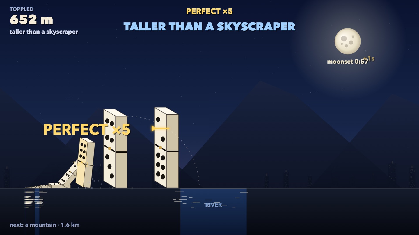 Dominoes taller than a skyscraper beside a river, with mountains behind and PERFECT x5 overhead.